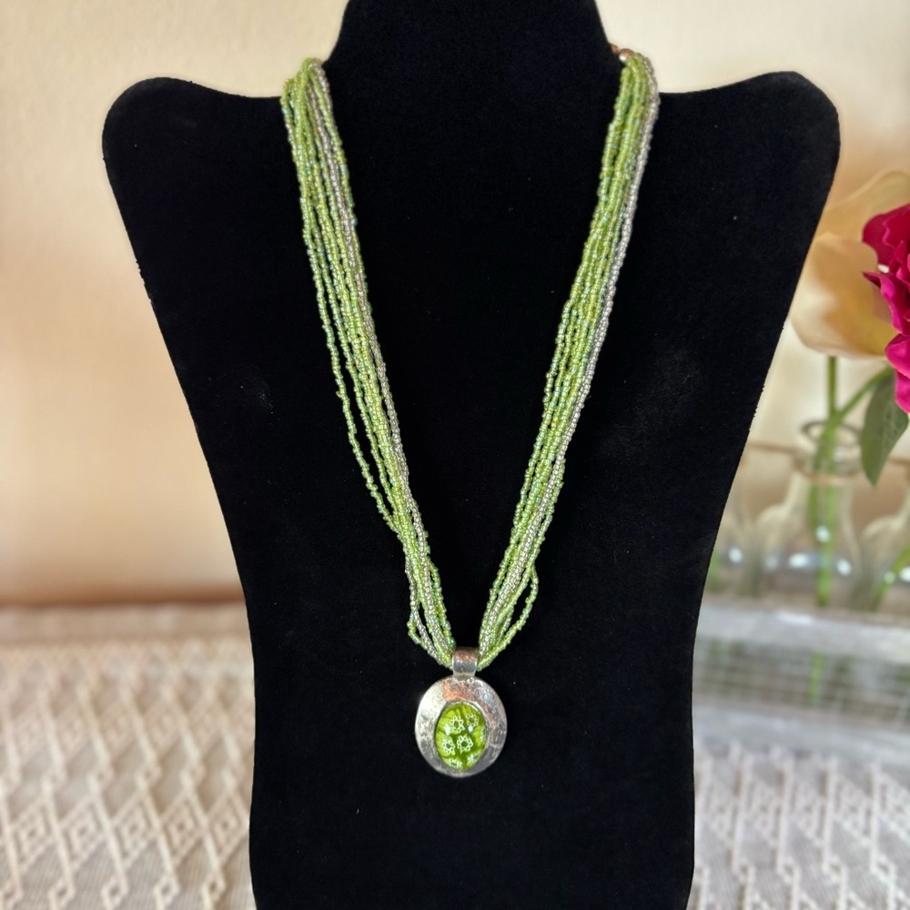 Green floral silver toned pendant‎ necklace with green and clear beaded strands.